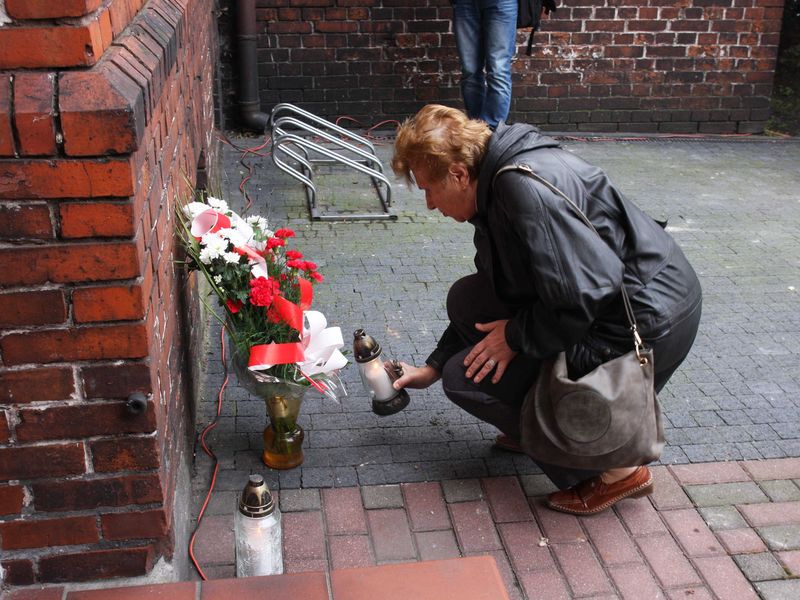 Znicze pod ścianą więzienia we Wrześni